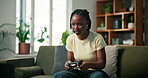 Online, video game and woman with controller, lounge and fun with digital entertainment and playing. Determined, gamer and black person with console in house, esports and concentration for next level