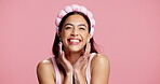 Face, beauty and woman in studio with wink, healthy skin and cosmetology in self care. Smile, confidence and female person with headband on pink background, wellness and treatment in skincare routine