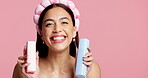 Face, girl or beauty bottles in studio for product review, hydration treatment or glow. Mockup space, skincare influencer or smile on pink background for moisturizer comparison or anti aging benefits