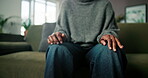 Nervous, hands and woman with stress on couch for counseling appointment, advice and support. Psychology, patient and person with anxiety on sofa for therapy consultation, help and wellness update.