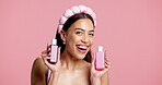 Face, beauty and woman with bottles, studio or happy with facial treatment promotion or mockup space. Influencer, laugh and person with positive review for skincare products, excited and background