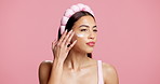 Woman, beauty and skincare with lotion in studio for facial treatment on a pink background. Female person, model or applying cosmetics with cream for skin moisturizer, glow or shine on mockup space