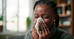 Sick, nose and black woman in house with tissue, flu season and illness with hayfever. Health, sinus issue and female person in living room with toilet paper, germ infection and sneeze in allergies.
