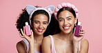 Face, friends or skincare bottles in studio for product review, results comparison and skin glow. Women, beauty influencers and happy on pink background for moisturizer launch and hydration benefits