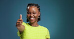 Thumbs up, face and black woman with vote in studio for happiness, approval and good review. Blue background, excited and african person with fashion, mockup space and ok or agreement with hand