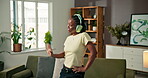 Dance, music and happy with black woman in home for streaming service, song playlist and energy. Headphones, audio subscription and connection with person in living room of house for radio and album