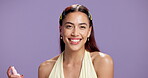 Face, spray and happy woman in studio with skincare for glowing skin, natural beauty and hydration. Smile, female person and mist for dermatology, cosmetic and facial treatment on purple background.