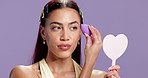 Makeup sponge, mirror and woman with aesthetic, beauty product or cosmetics powder in studio. Portrait, facial cosmetology or blending foundation for dermatology with self care on purple background