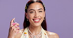 Face, fragrance and happy woman in studio with spray, hygiene product and scent for body odor. Smile, luxury perfume and female person with aroma, smell and natural cosmetic on purple background.