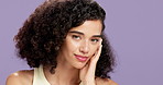 Woman, skincare and natural face in studio with beauty, touch and curly hair on purple background. Clear skin, dermatology and glow for wellness, self care and space for female person with afro