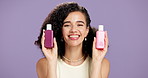 Products, skincare and woman in studio with beauty, natural and facial routine for glow. Smile, cosmetic and portrait of female person from Brazil with containers for dermatology by purple background