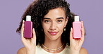 Skincare, smile and face of woman with containers in studio for natural, beauty and cosmetics. Happy, wellness and portrait of female person with products for dermatology by purple background.