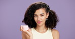 Woman, face cream and product for skincare, cosmetics or moisturizer with smile on purple background. Female person, model and beauty lotion for facial treatment, hydration or promo with mockup space