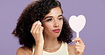 Mascara, mirror and woman with makeup, beauty product or cosmetics tools in studio. Smile, facial cosmetology or eyelash treatment for dermatology aesthetic for self care process on purple background