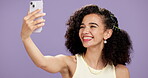 Happy, woman and selfie in studio with phone, confident and smile on social media app. Online, person and student on purple background with mobile, digital connection and technology for trends.