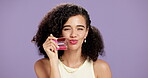 Happy, woman or face in studio with lip gloss, makeup or cosmetic for brand advertisement. Smile, person or mockup space on purple background with product, application or trends for female beauty.