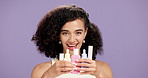 Skincare, smile and face of woman with products in studio for natural, beauty and cosmetics. Happy, wellness and portrait of female person with containers for dermatology by purple background.