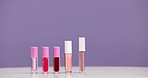 Lipstick, empty and makeup in studio, beauty product and cosmetology on purple background. Mockup space, tools and self care with cosmetics, aesthetic and grooming items with application and 