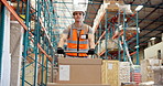 Logistics, man or walking with trolley in warehouse to transport boxes, stock distribution or shipping. Supply chain, worker and greeting in factory with moving package, low angle or inventory export
