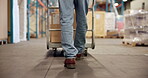 Logistics, legs of worker and trolley in warehouse to transport boxes, order loading or shipping. Supply chain, man and walk with stock in factory for moving package, inventory export or distribution