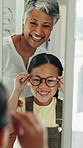 Glasses, optometrist and girl with smile, mirror and wellness with frames, sight and excited. Professional, optician and child with eyewear, clear vision or prescription with spectacles or reflection