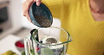 Blender, hands and seeds with woman in kitchen for detox, health or weight loss diet. Fruit, organic and smoothie ingredients with person in apartment for drink preparation, nutrition or wellness