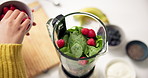 Hands, blender and raspberry in kitchen for smoothie, meal prep and process for healthy drink. Person, chef and organic ingredients for diet, nutrition or above for weight loss with wellness at house
