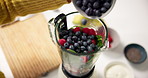 Hands, blender and blueberry in kitchen for smoothie, meal prep and process for healthy drink. Person, chef and organic ingredients for diet, nutrition or above for weight loss with wellness at house