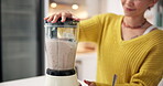 Smoothie, hand of woman or blender on kitchen counter for breakfast, gut health or digestion support. Healthy food,  balance diet or person with machine in home, nutrition or detox drink for wellness
