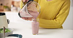 Person, hands and blender with smoothie in kitchen for diet, healthy drink or milkshake in home. Closeup, nutritionist or pour with mixer in glass for natural organic beverage or weight loss in house