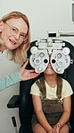 Optometrist, woman and girl with phoropter, happy and eye test for vision, talk and assessment at clinic. Mature person, ophthalmologist and child with medical equipment for eyesight exam at hospital
