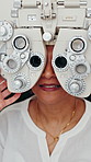 Hands, optometrist and woman with phoropter for eye exam, assessment and check vision at clinic. People, ophthalmologist and patient with medical equipment, lens and test eyesight at optic hospital