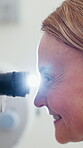 Slit lamp, eye test and woman in clinic, profile and equipment for vision assessment and healthcare. Ophthalmology, patient and person with machine, flare and eyesight medical appointment in hospital