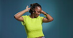 Dancing, black woman and fun energy in studio with rhythm, music and fashion style by space. Happiness, celebration and female dancer on blue background with freedom, excited and clapping in outfit