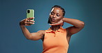 Black woman, selfie and influencer in studio with smile, peace sign and pout on blue background. African girl, happy and profile picture with kiss, mock up space or content creation on social media