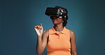 VR, scroll or black woman in studio with headset, virtual game or augmented reality in digital world. Immersive, futuristic and girl on blue background with tech, streaming or connection in metaverse