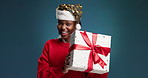 Happy, christmas and face of black woman with gift for tradition, festive or holiday surprise. Excited, smile and portrait of African person with xmas present for celebration by studio background.