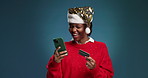 Happy, black woman or credit card with phone for christmas shopping on a blue studio background. Female person, shopper or debit with mobile smartphone for festive discount, app or ecommerce on space