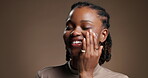 Skincare, cream and smile with black woman in studio for beauty, self care and cosmetics. Dermatology, mockup space and shine with person  on brown background for aesthetic, clear skin and collagen