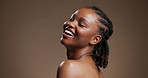 Skincare, face and happy with black woman in studio for beauty, body care and glow. Dermatology, mockup space and shine with person on brown background for aesthetic, clear skin and collagen