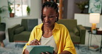 Black woman, relax and writing on stylus at house for research, editing article and copywriting. Person, freelancer and tablet for editor feedback, reading newsletter and draft update for publication