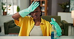 Sweat, cleaning and black woman in living room for hygiene to remove dust, dirt or bacteria for health. African person, spray sanitizer and tired student with chores with detergent for wellness