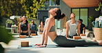 Yoga, class or people in backyard with stretching, mindfulness or relax in body wellness. Backbend, motivation or instructor in outdoor with mobility, muscle or spinal improvement in group practice.