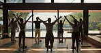 Back, people and stretching for yoga in class, holistic fitness and spiritual balance with instructor. Group, community and namaste pose for meditation, mindfulness and instructions of wellness hobby