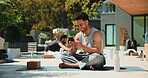 Yoga, texting and man outdoors with phone, smile and meditation for wellness. Happy person, fitness and relaxation in garden with people, online mindfulness and technology for mental health.