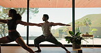Yoga, class or people in studio with stretching, mindfulness or relax in body wellness. Warrior pose, motivation or instructor in gym with mobility, balance and stamina improvement in shared practice