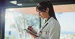 Tablet, woman and doctor in clinic for writing notes with medical research or information. Digital technology, professional and female healthcare worker planning diagnosis or treatment in hospital.