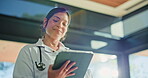 Healthcare, stethoscope and tablet with woman doctor in hospital for insurance or telehealth. App, cardiology and medical with happy medicine professional in clinic for diagnosis, results or review