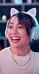 Gamer, headphones and excited woman in home with podcast for gaming win, competition and fun hobby. Influencer, person or live stream in house with celebration, progress and next level in video game.