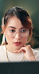 Glasses, laptop and programming with woman web designer in office for development or engineering. Computer, information and reading with design professional in creative workplace for launch or update
